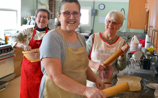 3 smiling ladies cooking