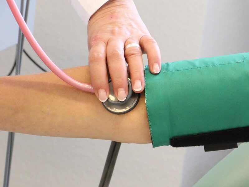 medical professional taking blood pressure