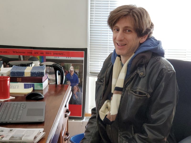 smiling man sitting at desk