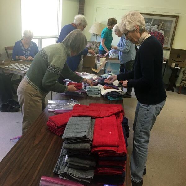 group of people assembling health kits